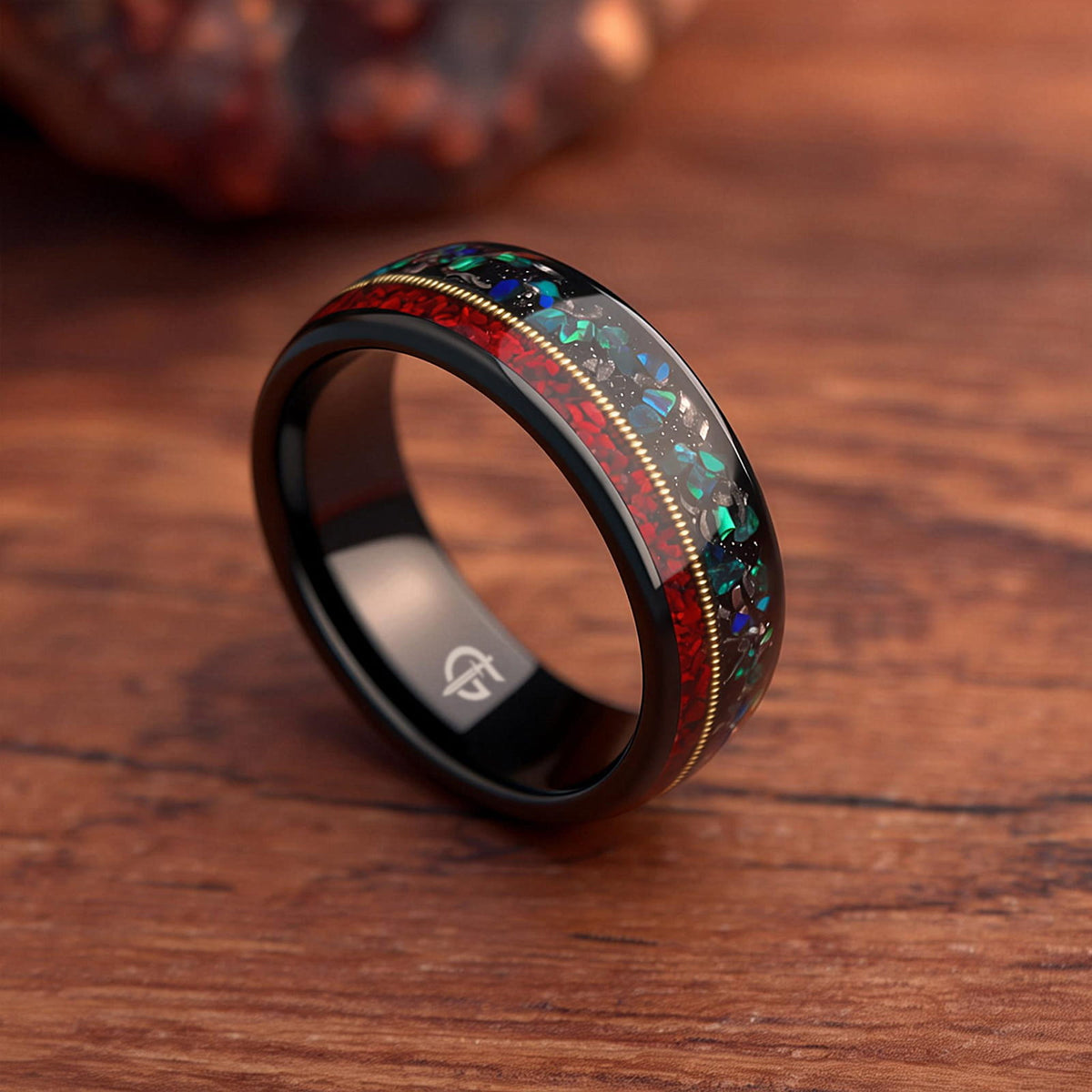 Polished black tungsten ring with gold-colored guitar string between red dinosaur bone and mixed meteorite and blue-green opal