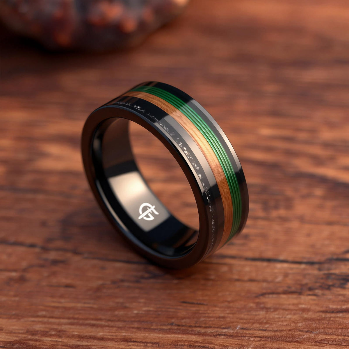 Polished black tungsten carbide ring with green fishing line, brown whiskey barrel wood and silver-gray meteorite