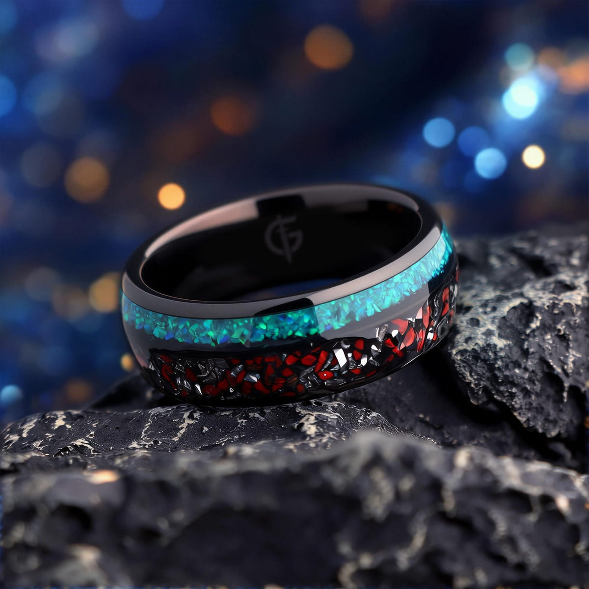 Black domed tungsten ring with red and silver-gray fragments beside a blue-green opal inlay.