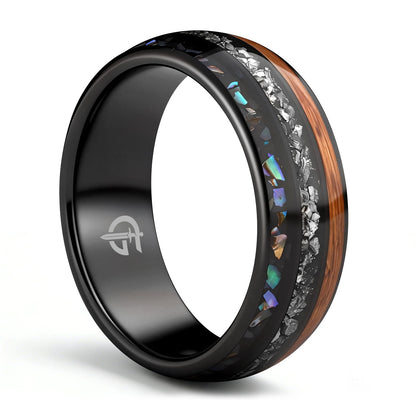 Black domed ring with brown wood, silver-gray meteorite, and iridescent abalone in three separate channels.