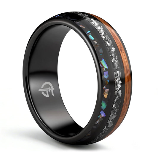Black domed ring with brown wood, silver-gray meteorite, and iridescent abalone in three separate channels.