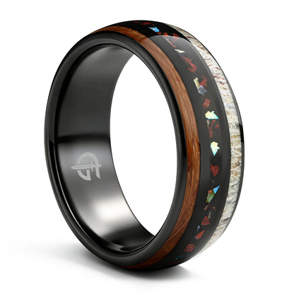 Black tungsten ring with wood and pale antler framing red dinosaur bone and iridescent abalone shell