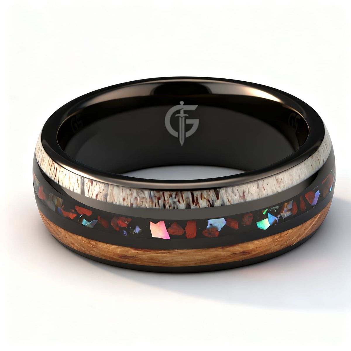 Black tungsten ring with wood and pale antler framing red dinosaur bone and iridescent abalone shell