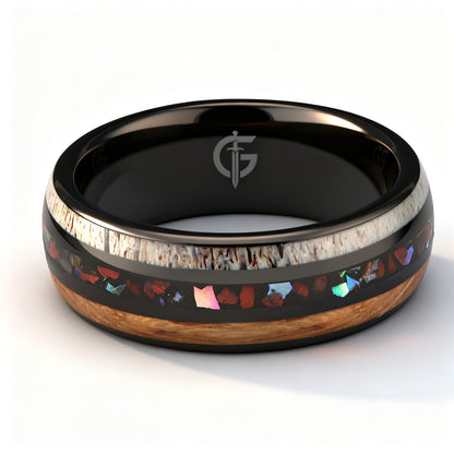 Black tungsten ring with wood and pale antler framing red dinosaur bone and iridescent abalone shell