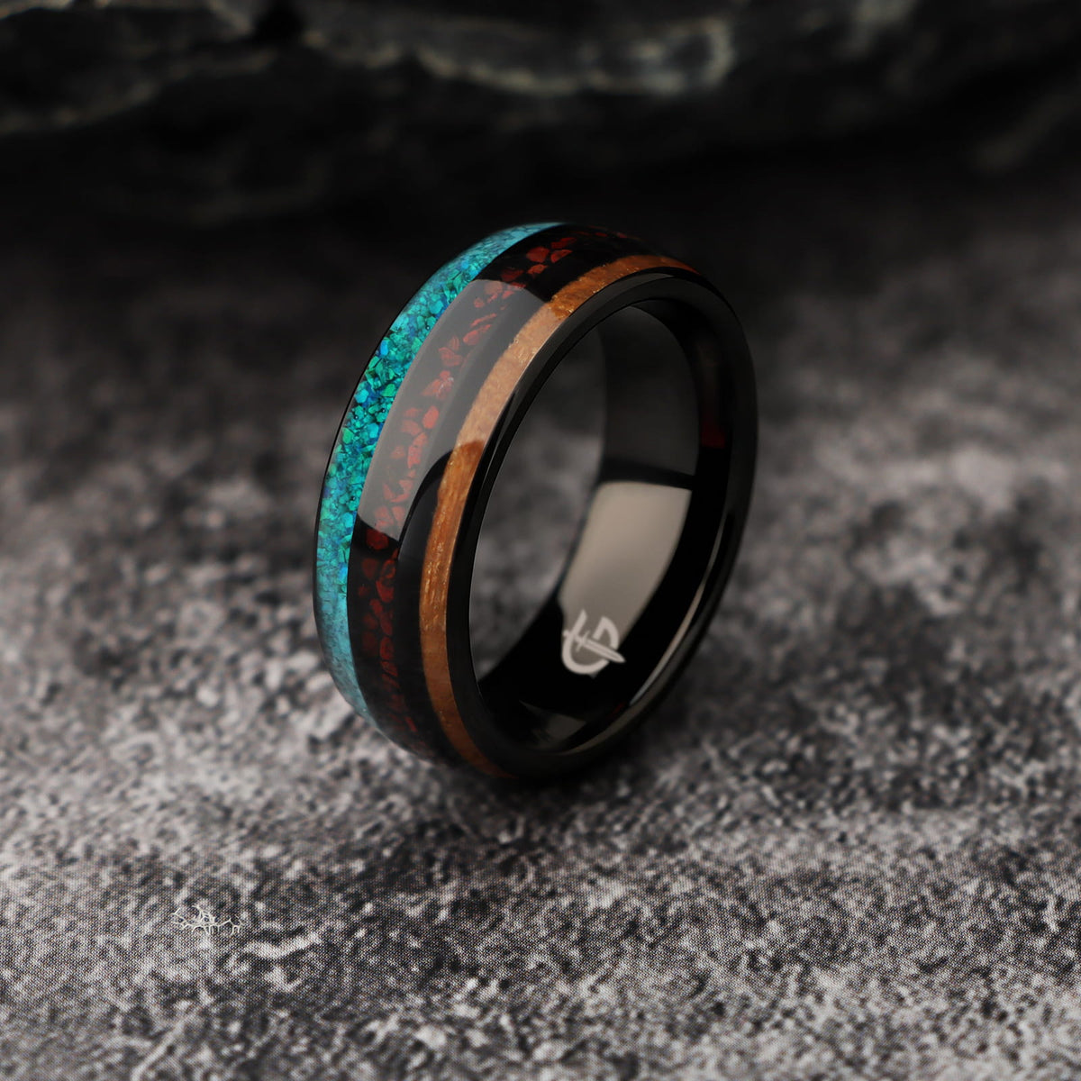 Polished black tungsten ring with brown wood, red dinosaur bone and blue-green turquoise in three bands