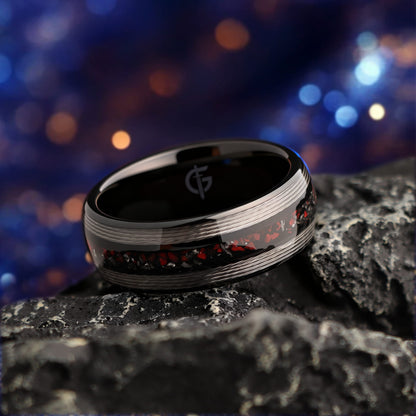 Black tungsten ring with silver-tone fishing line flanking a red dinosaur bone and silver-gray meteorite center