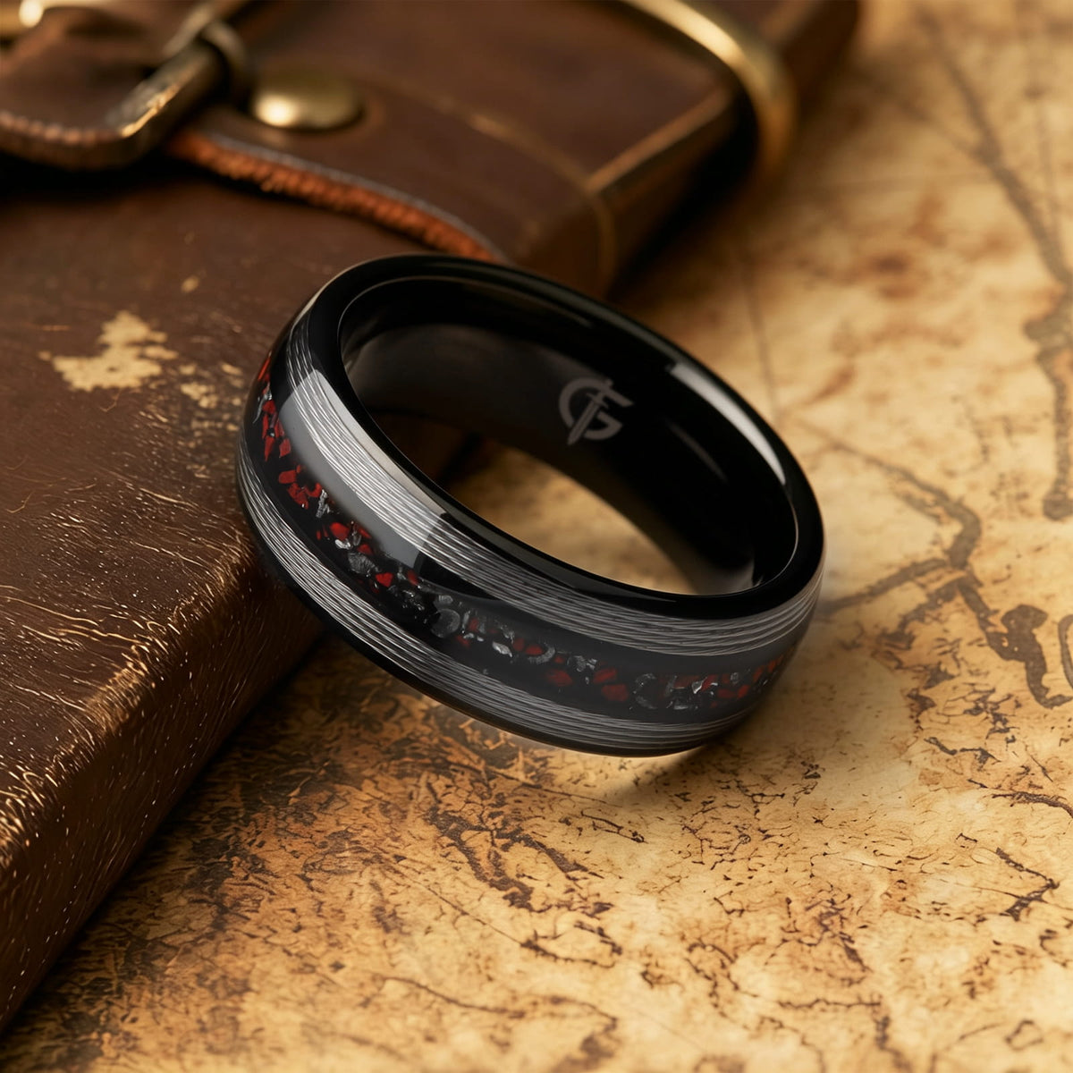 Black tungsten ring with silver-tone fishing line flanking a red dinosaur bone and silver-gray meteorite center