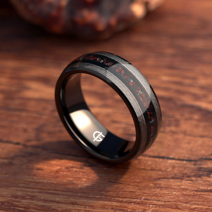 Black tungsten ring with silver-tone fishing line flanking a red dinosaur bone and silver-gray meteorite center