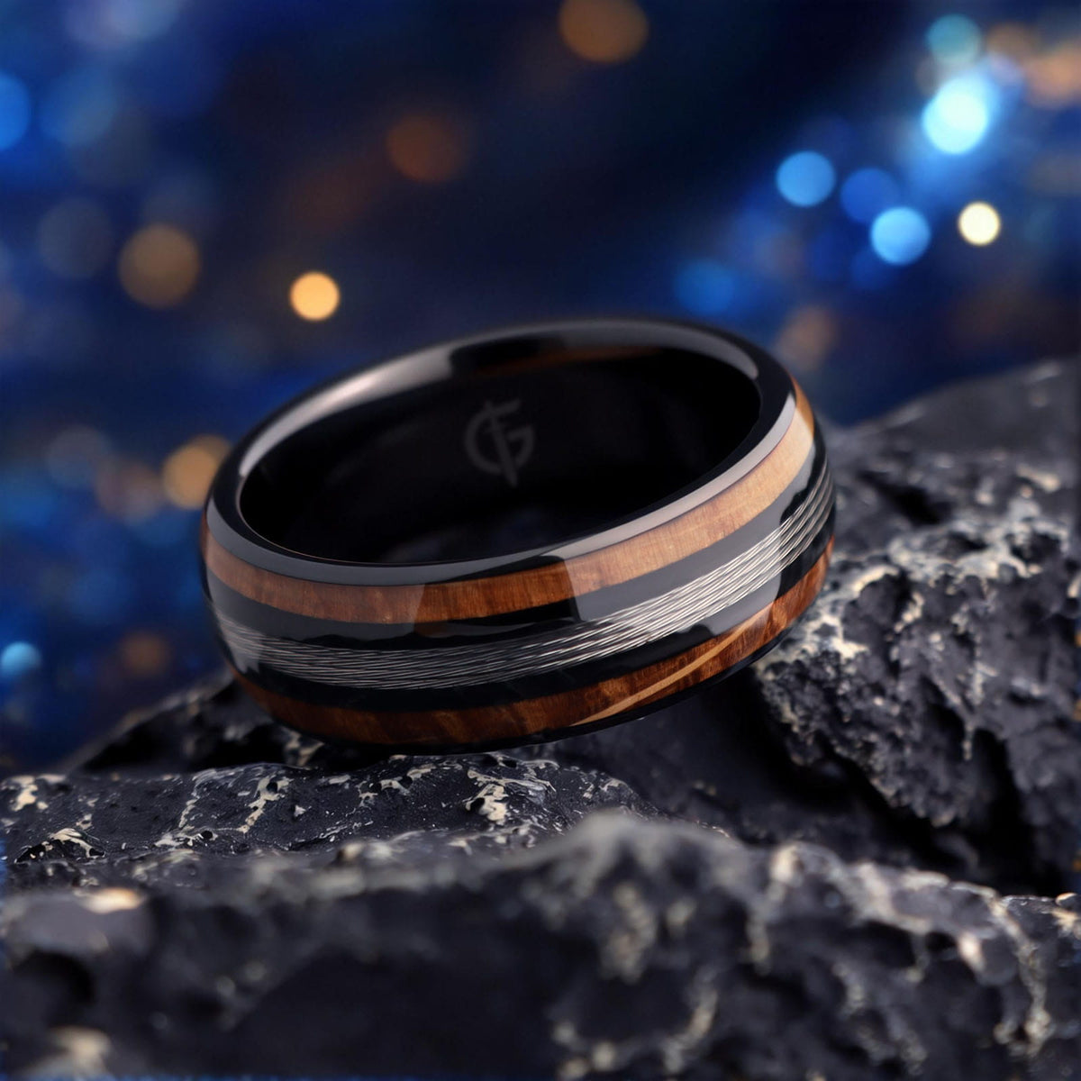 Black tungsten ring with silver-tone fishing line centered between two whiskey barrel wood bands