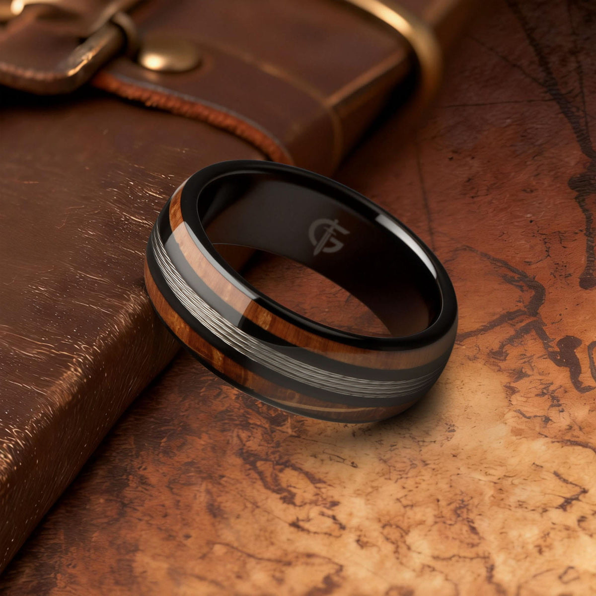 Black tungsten ring with silver-tone fishing line centered between two whiskey barrel wood bands